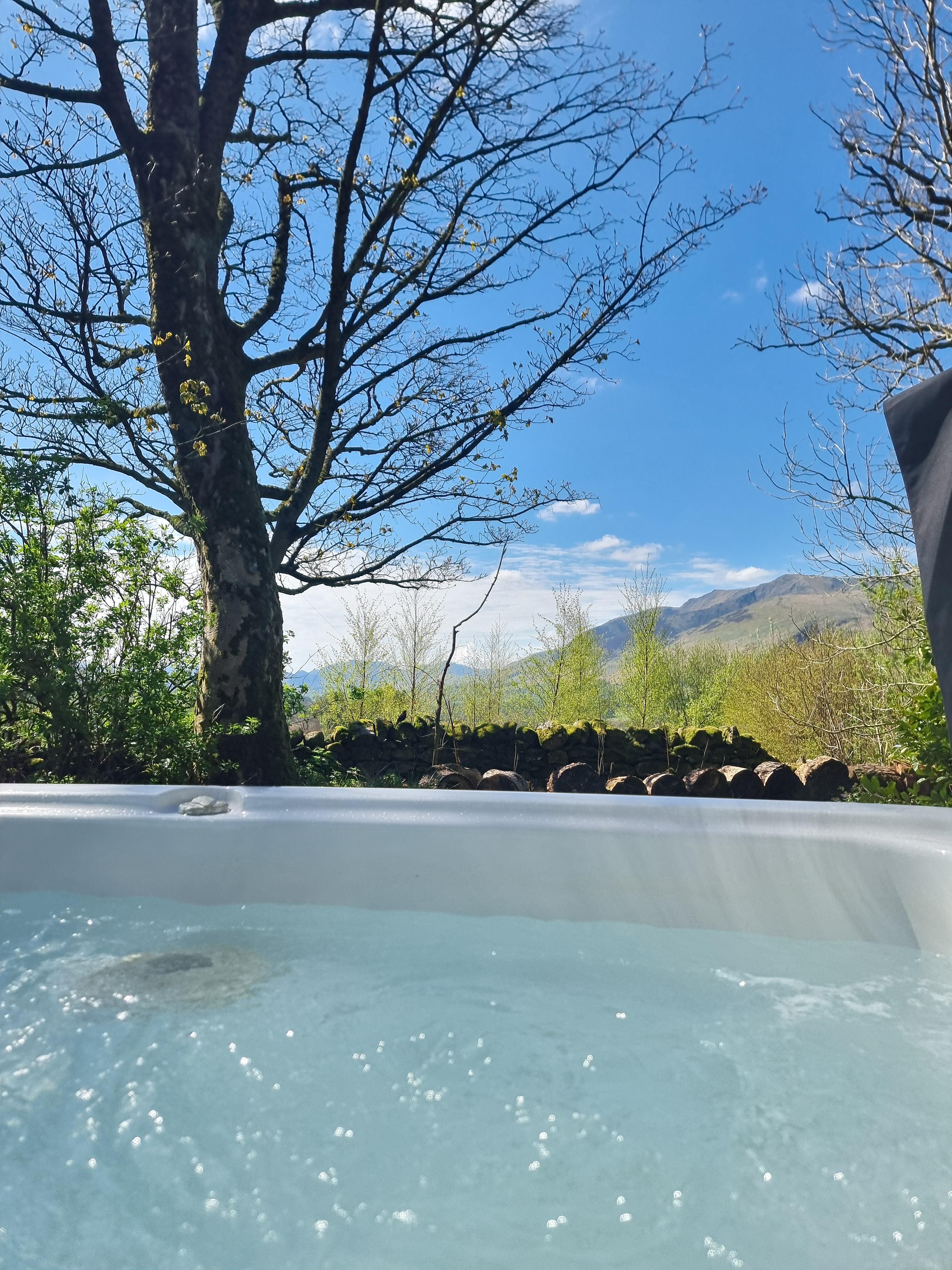 Hot tub with mountain views at The Farm House in Troutbeck
